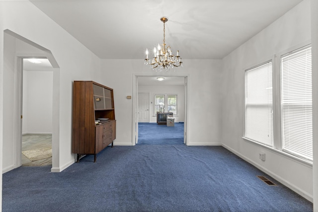 622 Tromley St, Inkster, MI 48141 - spare room with dark carpet, a chandelier, and arched walkways