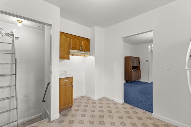 622 Tromley St, Inkster, MI 48141 - kitchen featuring under cabinet range hood, brown cabinetry, and light countertops