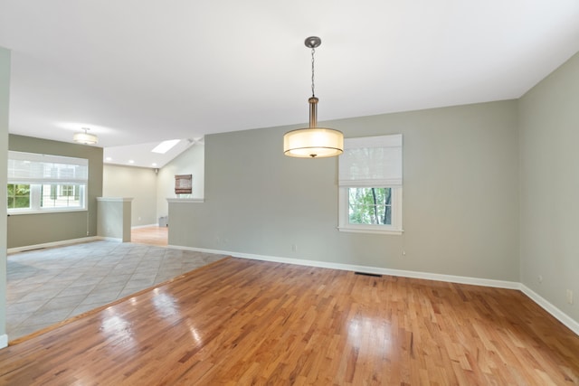 2113 Ridgeway Rd, Jackson, MI 49203 - empty room featuring light wood finished floors and a skylight