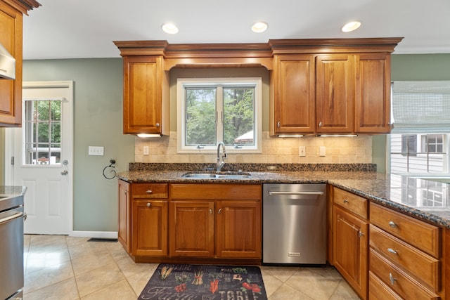 2113 Ridgeway Rd, Jackson, MI 49203 - kitchen featuring stainless steel dishwasher, brown cabinetry, healthy amount of natural light, tasteful backsplash, and recessed lighting