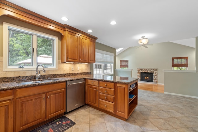 2113 Ridgeway Rd, Jackson, MI 49203 - kitchen with dishwasher, a ceiling fan, tasteful backsplash, brown cabinetry, and a peninsula