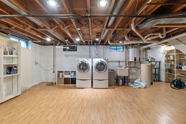 2113 Ridgeway Rd, Jackson, MI 49203 - below grade area featuring separate washer and dryer, wood finished floors, and a water softener system