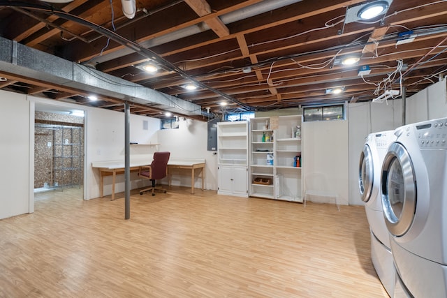 2113 Ridgeway Rd, Jackson, MI 49203 - below grade area featuring a desk, wood finished floors, electric panel, and washer and clothes dryer