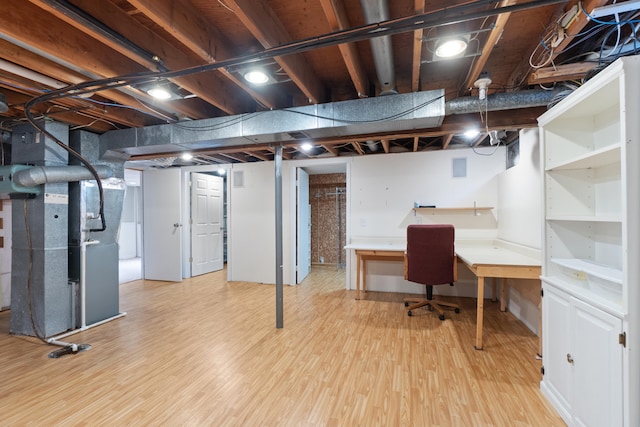 2113 Ridgeway Rd, Jackson, MI 49203 - basement featuring light wood-style flooring, heating unit, and an office area