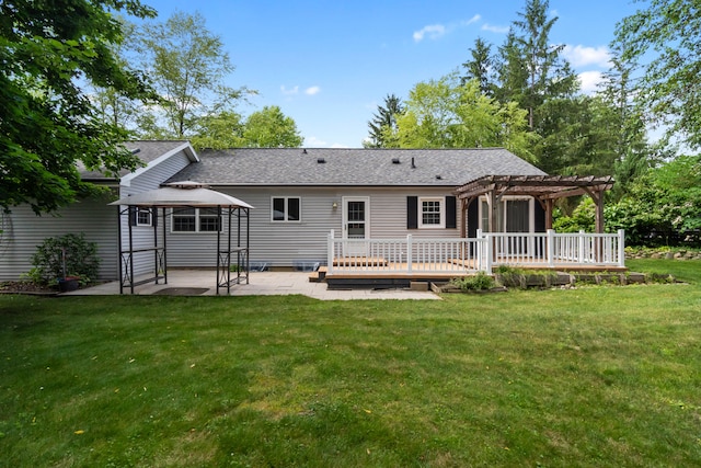 2113 Ridgeway Rd, Jackson, MI 49203 - rear view of house featuring a pergola, a gazebo, a deck, a lawn, and a shingled roof