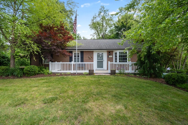 2113 Ridgeway Rd, Jackson, MI 49203 - single story home featuring brick siding, covered porch, a front lawn, and a shingled roof
