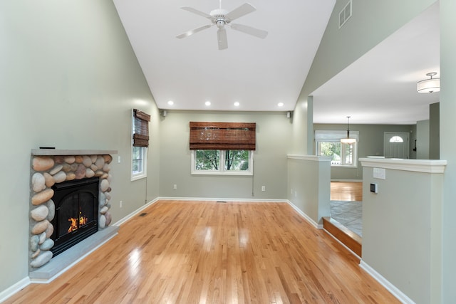 2113 Ridgeway Rd, Jackson, MI 49203 - unfurnished living room featuring a fireplace, wood finished floors, ceiling fan, recessed lighting, and high vaulted ceiling