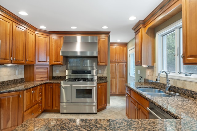 2113 Ridgeway Rd, Jackson, MI 49203 - kitchen featuring stainless steel appliances, wall chimney range hood, brown cabinetry, dark stone counters, and recessed lighting