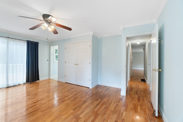 2113 Ridgeway Rd, Jackson, MI 49203 - unfurnished bedroom featuring light wood-style flooring, ornamental molding, a closet, and ceiling fan