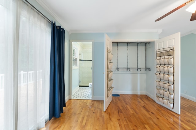 2113 Ridgeway Rd, Jackson, MI 49203 - unfurnished bedroom featuring crown molding, light wood finished floors, ensuite bath, a ceiling fan, and a closet