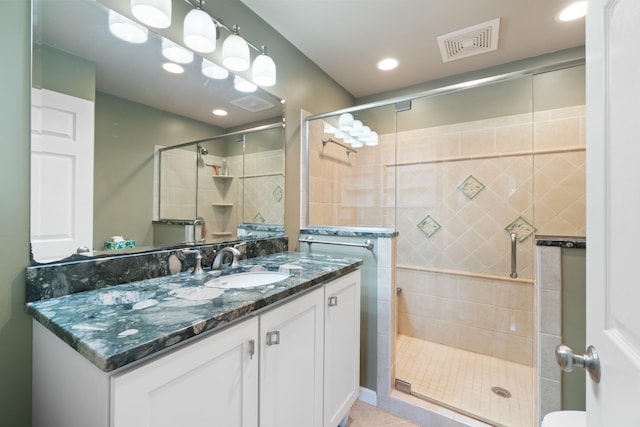 2113 Ridgeway Rd, Jackson, MI 49203 - full bathroom with vanity, a stall shower, tile patterned floors, and recessed lighting