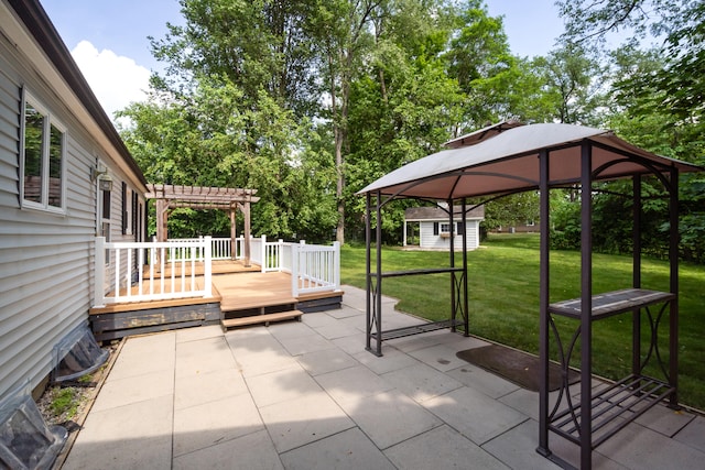 2113 Ridgeway Rd, Jackson, MI 49203 - view of patio featuring a pergola, a wooden deck, an outbuilding, and a gazebo