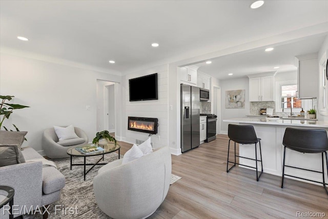 29924 Taylor St, Saint Clair Shores, MI 48082 - living room featuring a large fireplace, recessed lighting, and light wood-type flooring