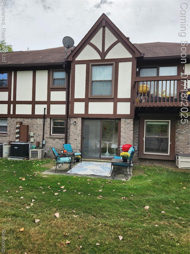 19370 W 11 Mile Rd, Lathrup Village, MI 48076 - rear view of house featuring brick siding, a balcony, a lawn, and stucco siding