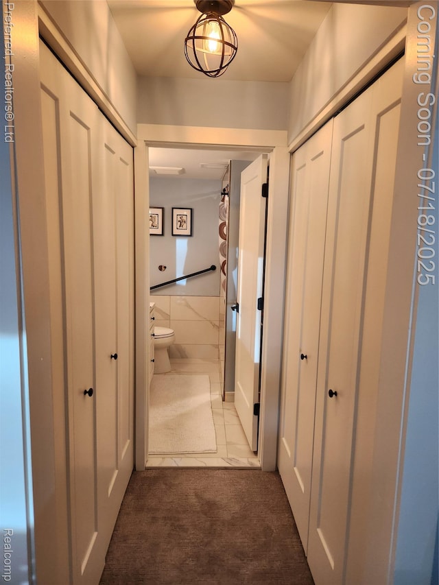19370 W 11 Mile Rd, Lathrup Village, MI 48076 - hallway featuring tile walls, carpet floors, and tile patterned floors