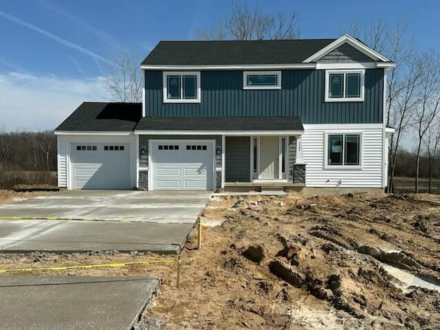 LOT107 Butternut Dr, Wayland, MI 49348 - traditional-style house with driveway, a garage, and covered porch