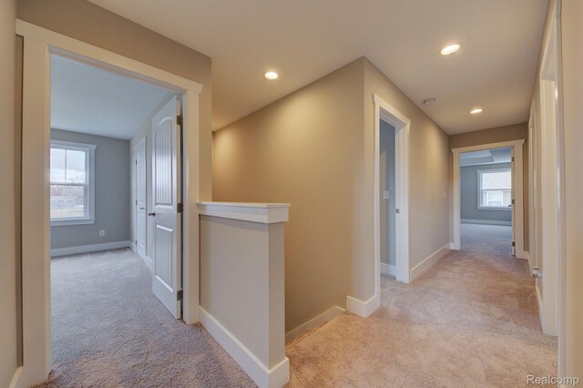 MOH45 Birkdale Dr Unit 45, Howell, MI 48843 - hallway featuring light colored carpet, an upstairs landing, and recessed lighting