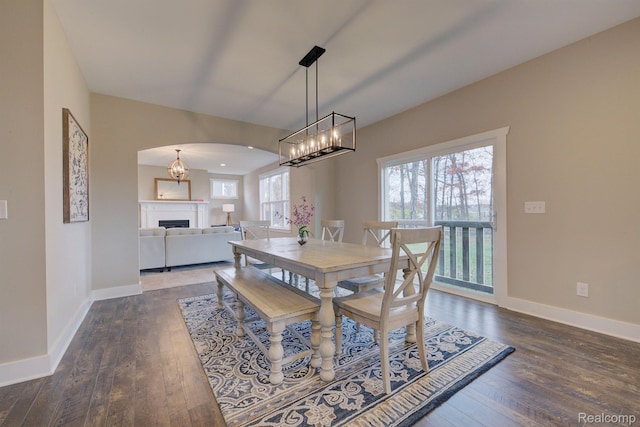 MOH45 Birkdale Dr Unit 45, Howell, MI 48843 - dining area with arched walkways, hardwood / wood-style flooring, a chandelier, and a fireplace