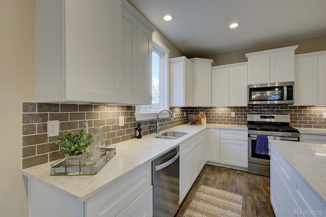 MOH45 Birkdale Dr Unit 45, Howell, MI 48843 - kitchen featuring appliances with stainless steel finishes, dark wood-type flooring, white cabinets, light stone counters, and recessed lighting