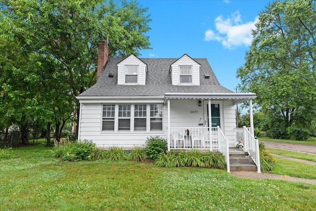 21197 Nummer St, Warren, MI 48089 - view of front of property with a porch, a front lawn, a chimney, and roof with shingles