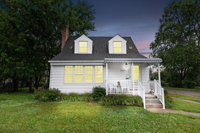 21197 Nummer St, Warren, MI 48089 - view of front of property with covered porch, a chimney, a lawn, and roof with shingles