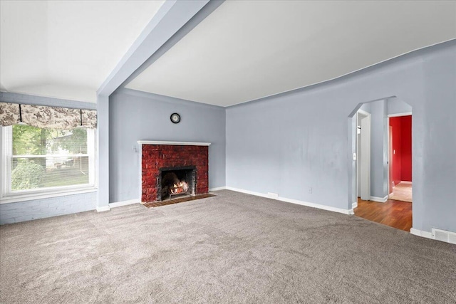 21197 Nummer St, Warren, MI 48089 - unfurnished living room with carpet floors, arched walkways, and a brick fireplace