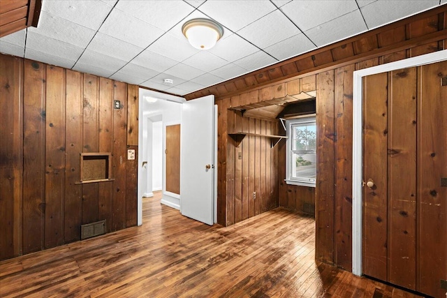 21197 Nummer St, Warren, MI 48089 - unfurnished bedroom featuring wood walls and hardwood / wood-style flooring