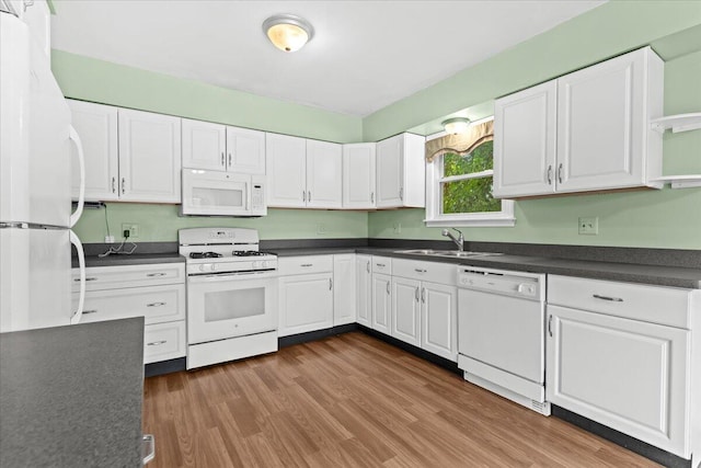 21197 Nummer St, Warren, MI 48089 - kitchen featuring white appliances, dark countertops, white cabinets, and dark wood-style flooring