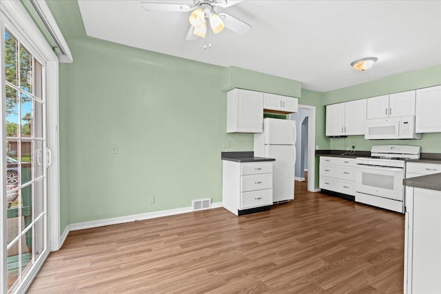 21197 Nummer St, Warren, MI 48089 - kitchen featuring white appliances, dark countertops, white cabinets, and light wood-style floors