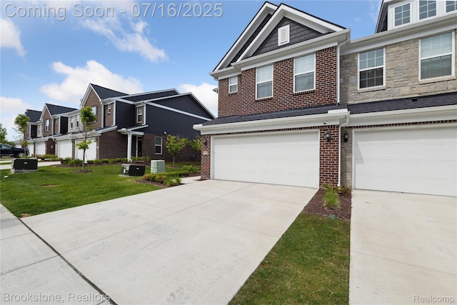765 Hummingbird Dr, Rochester Hills, MI 48307 - traditional-style house with driveway, a garage, brick siding, and a front lawn
