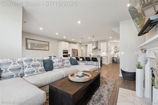 765 Hummingbird Dr, Rochester Hills, MI 48307 - living room with recessed lighting and a fireplace with flush hearth
