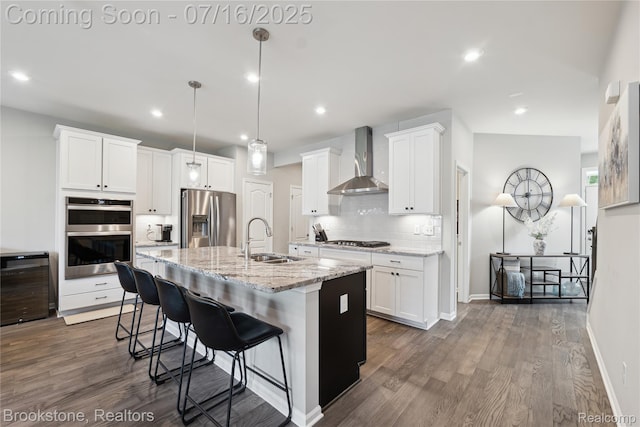 765 Hummingbird Dr, Rochester Hills, MI 48307 - kitchen with appliances with stainless steel finishes, wall chimney exhaust hood, tasteful backsplash, a breakfast bar, and white cabinetry