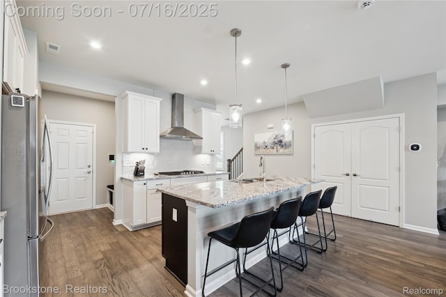 765 Hummingbird Dr, Rochester Hills, MI 48307 - kitchen with wall chimney range hood, appliances with stainless steel finishes, dark wood-type flooring, white cabinets, and recessed lighting