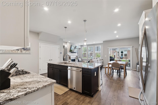 765 Hummingbird Dr, Rochester Hills, MI 48307 - kitchen with stainless steel appliances, dark cabinets, a center island with sink, recessed lighting, and dark wood-style floors