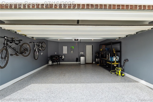 765 Hummingbird Dr, Rochester Hills, MI 48307 - garage with baseboards and a garage door opener