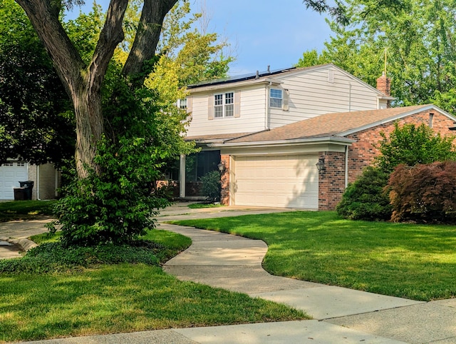 20519 Mauer St, Saint Clair Shores, MI 48080 - view of front of home with brick siding, a garage, a front lawn, and a chimney