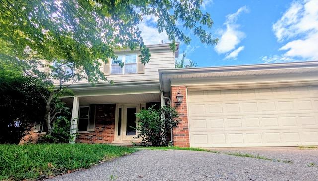 20519 Mauer St, Saint Clair Shores, MI 48080 - view of front of home featuring brick siding, an attached garage, and driveway