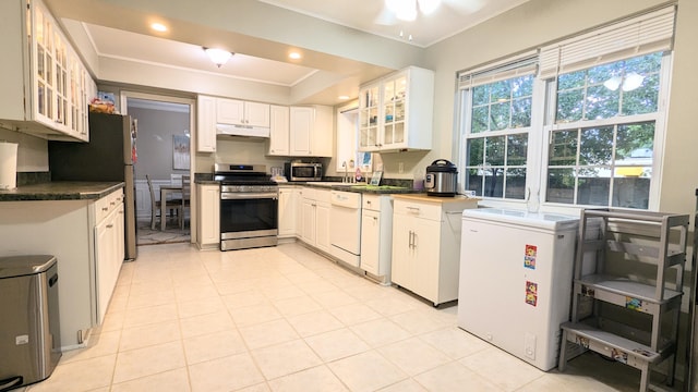 20519 Mauer St, Saint Clair Shores, MI 48080 - kitchen featuring appliances with stainless steel finishes, under cabinet range hood, ornamental molding, glass insert cabinets, and dark countertops