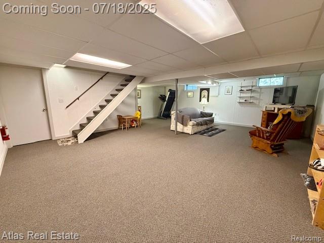 8354 Ridge Rd, Goodrich, MI 48438 - below grade area with stairway, carpet floors, and a paneled ceiling