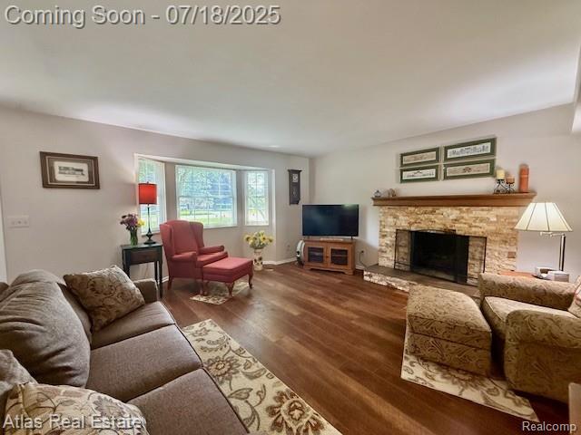 8354 Ridge Rd, Goodrich, MI 48438 - living area featuring wood finished floors and a stone fireplace