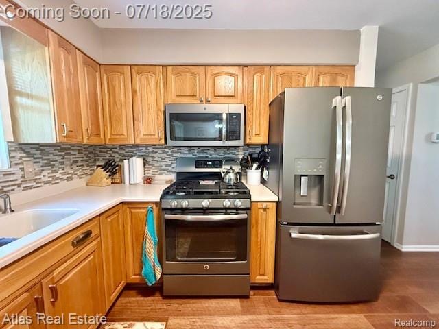 8354 Ridge Rd, Goodrich, MI 48438 - kitchen featuring appliances with stainless steel finishes, light countertops, and backsplash