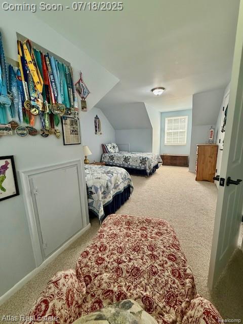 8354 Ridge Rd, Goodrich, MI 48438 - carpeted bedroom with vaulted ceiling and baseboards