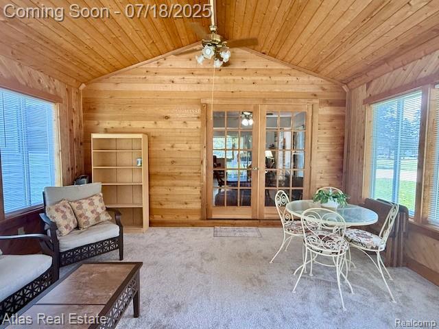 8354 Ridge Rd, Goodrich, MI 48438 - living area with lofted ceiling, wood walls, french doors, ceiling fan, and wooden ceiling