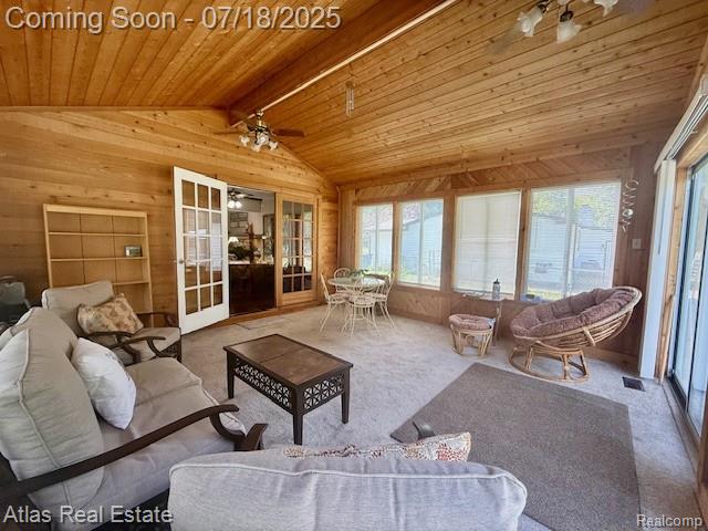 8354 Ridge Rd, Goodrich, MI 48438 - carpeted living room with wooden walls, wood ceiling, french doors, and a ceiling fan