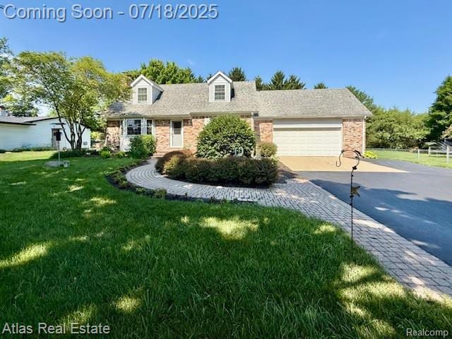 8354 Ridge Rd, Goodrich, MI 48438 - cape cod-style house featuring brick siding, driveway, a garage, and a front yard