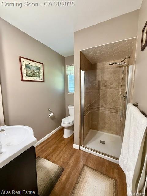 8354 Ridge Rd, Goodrich, MI 48438 - full bath with wood finished floors, a stall shower, and vanity