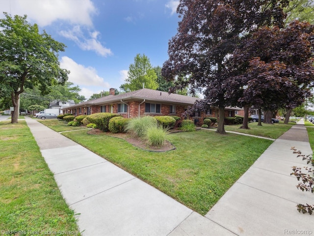 1010 Laprairie St, Ferndale, MI 48220 - ranch-style house with a chimney, brick siding, and a front yard