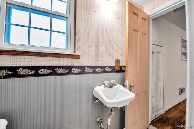 3870 Benstein Rd, Commerce Twp, MI 48382 - bathroom featuring wallpapered walls and wood finished floors