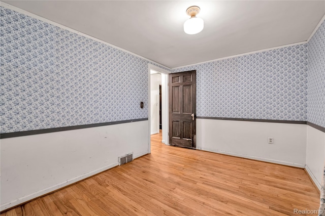 3870 Benstein Rd, Commerce Twp, MI 48382 - unfurnished room with wood finished floors, wallpapered walls, and crown molding