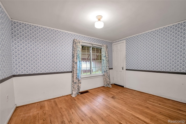3870 Benstein Rd, Commerce Twp, MI 48382 - empty room featuring wallpapered walls, crown molding, and wood finished floors